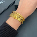 YSL Wide Monogram Engraved Gold Cuff Bracelet