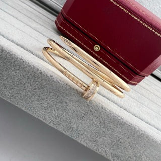 Cartier Juste un Clou bracelet, thick model, with diamonds at the ends and on the three-loop design.