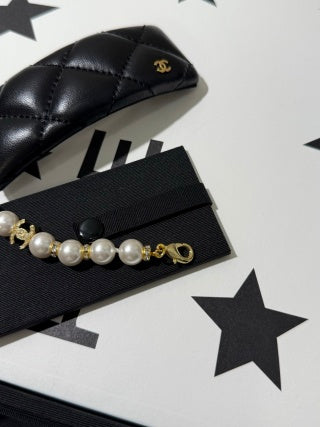 Chanel light gold bracelet with white pearls and full pavé-set stones.