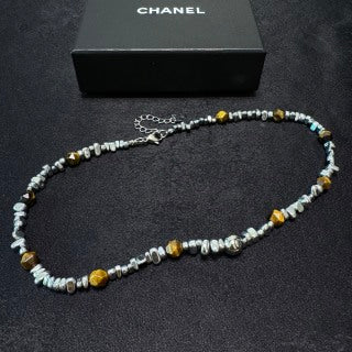 Chunky necklace featuring tiger's eye, silver beads, and crushed silver elements.