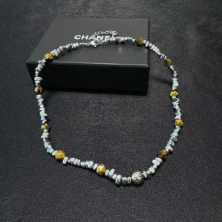 Chunky necklace featuring tiger's eye, silver beads, and crushed silver elements.