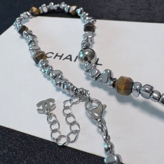 Chunky necklace featuring tiger's eye, silver beads, and crushed silver elements.