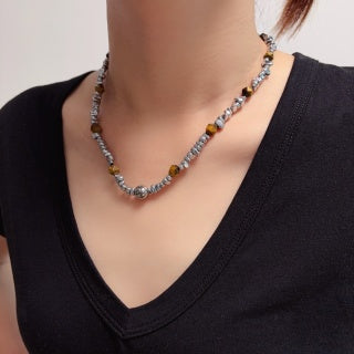 Chunky necklace featuring tiger's eye, silver beads, and crushed silver elements.