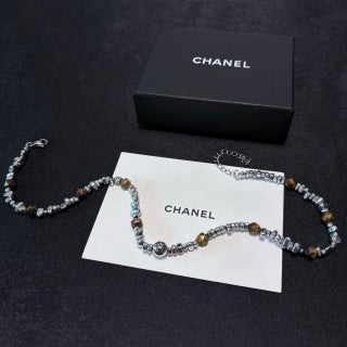 Chunky necklace featuring tiger's eye, silver beads, and crushed silver elements.