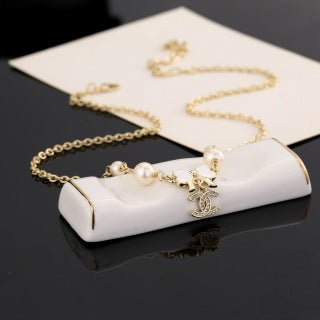 Chanel Pearl Bow Charm Necklace